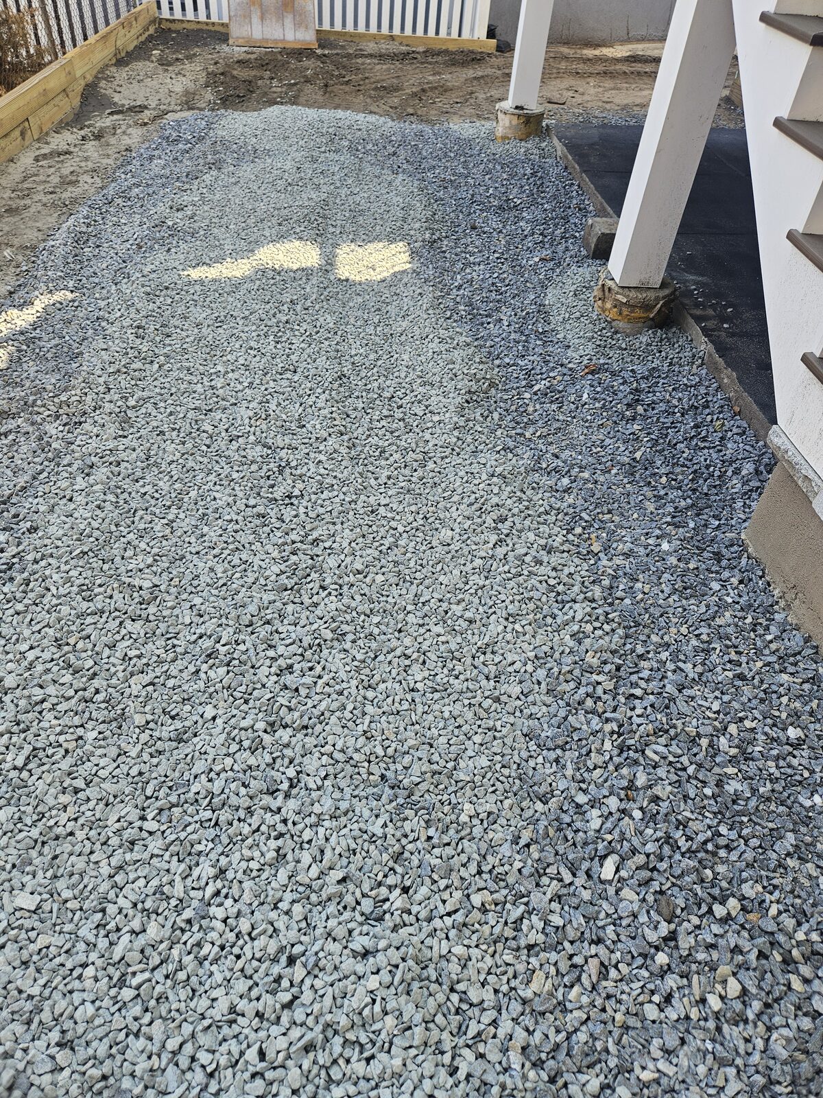 Tape measure showing a 16-inch excavation depth for a permeable driveway base in Somerville, MA