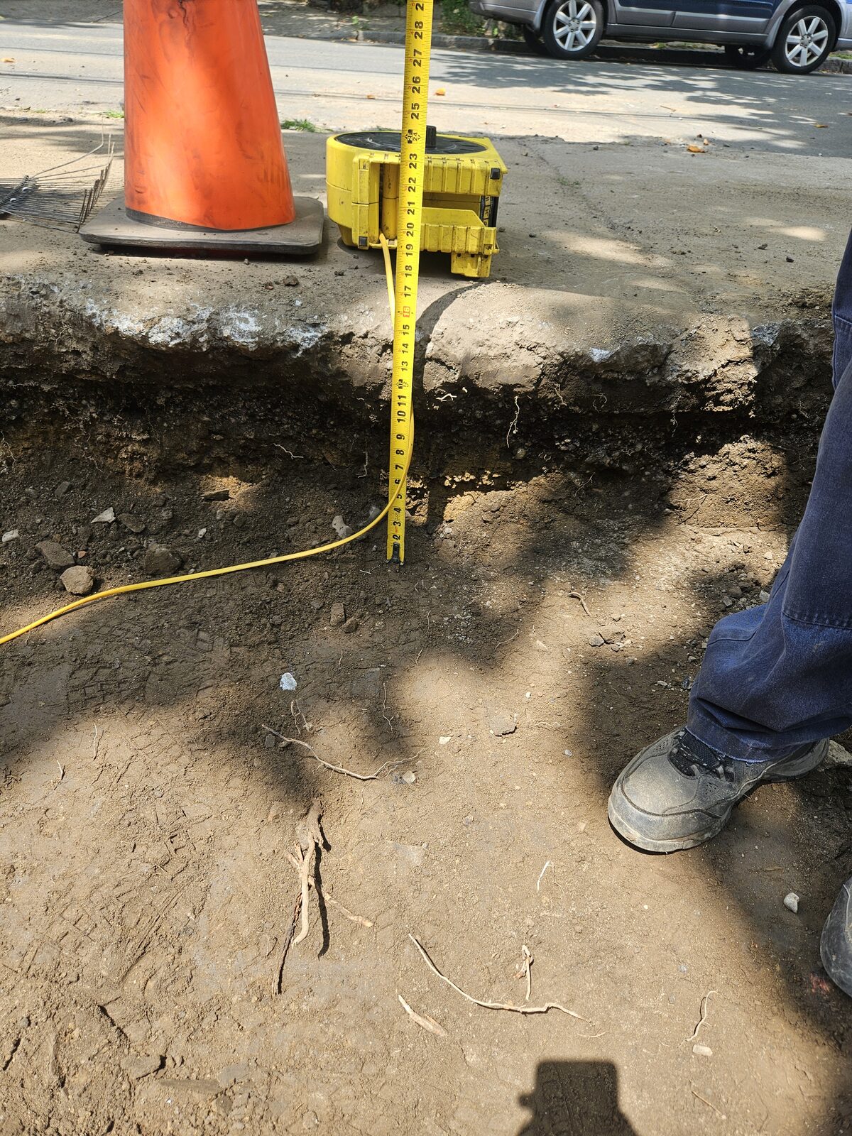 Three-quarter-inch open-graded clean crushed stone base laid for a permeable driveway in Somerville, MA